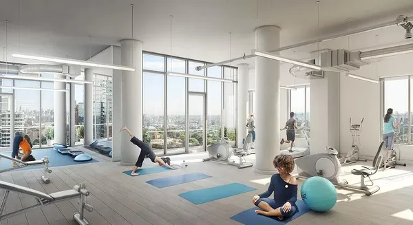 a living room with couch floor to ceiling windows and a ceiling fan