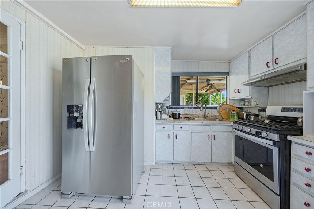 117 Spanner Street Monrovia, CA 91016 - Photo 8 of 33 a kitchen with stainless steel appliances granite countertop a stove a refrigerator and a cabinets