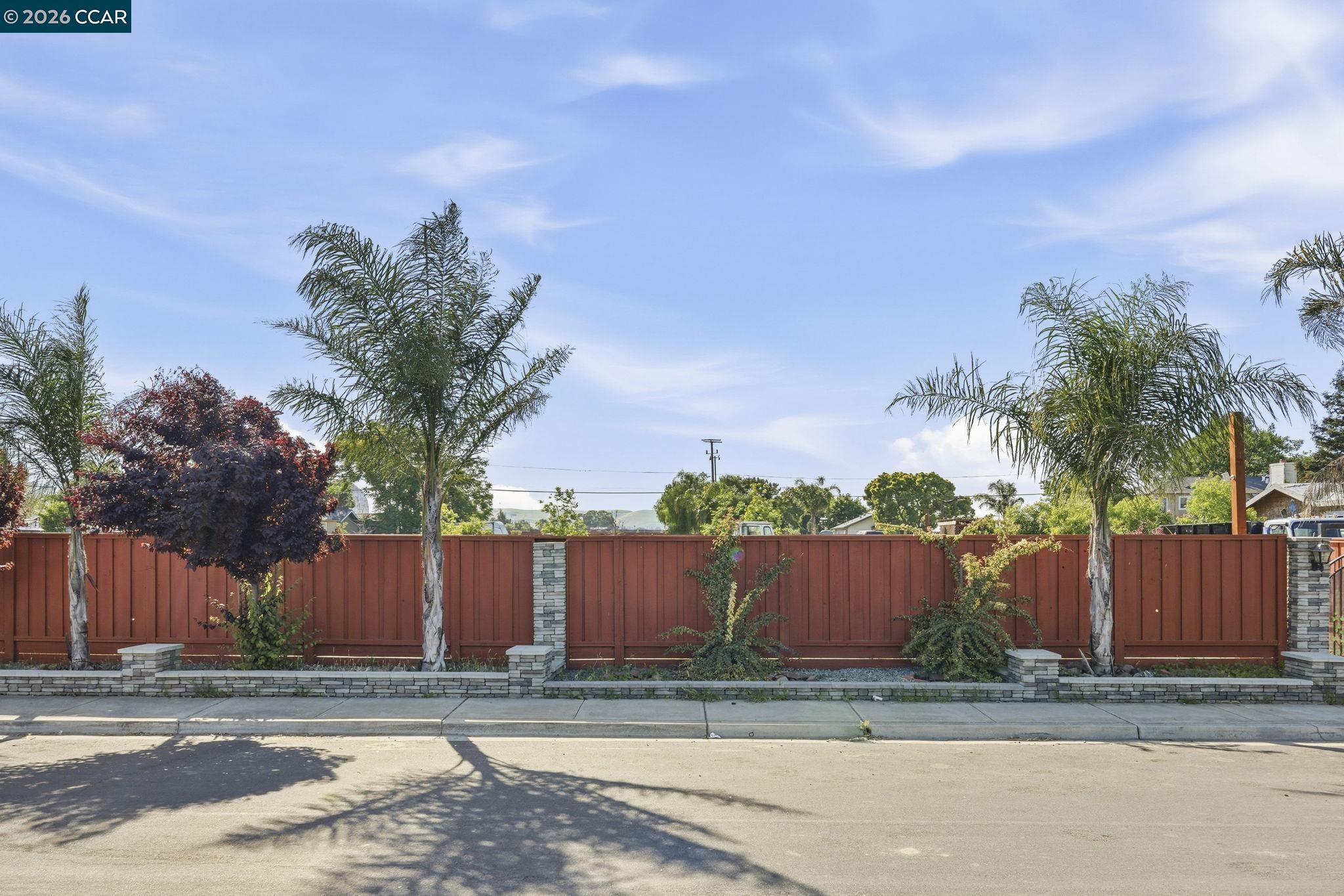 205 Solano Avenue Bay Point, CA 94565 - Photo 3 of 16 front view of a house with a yard and wooden fence