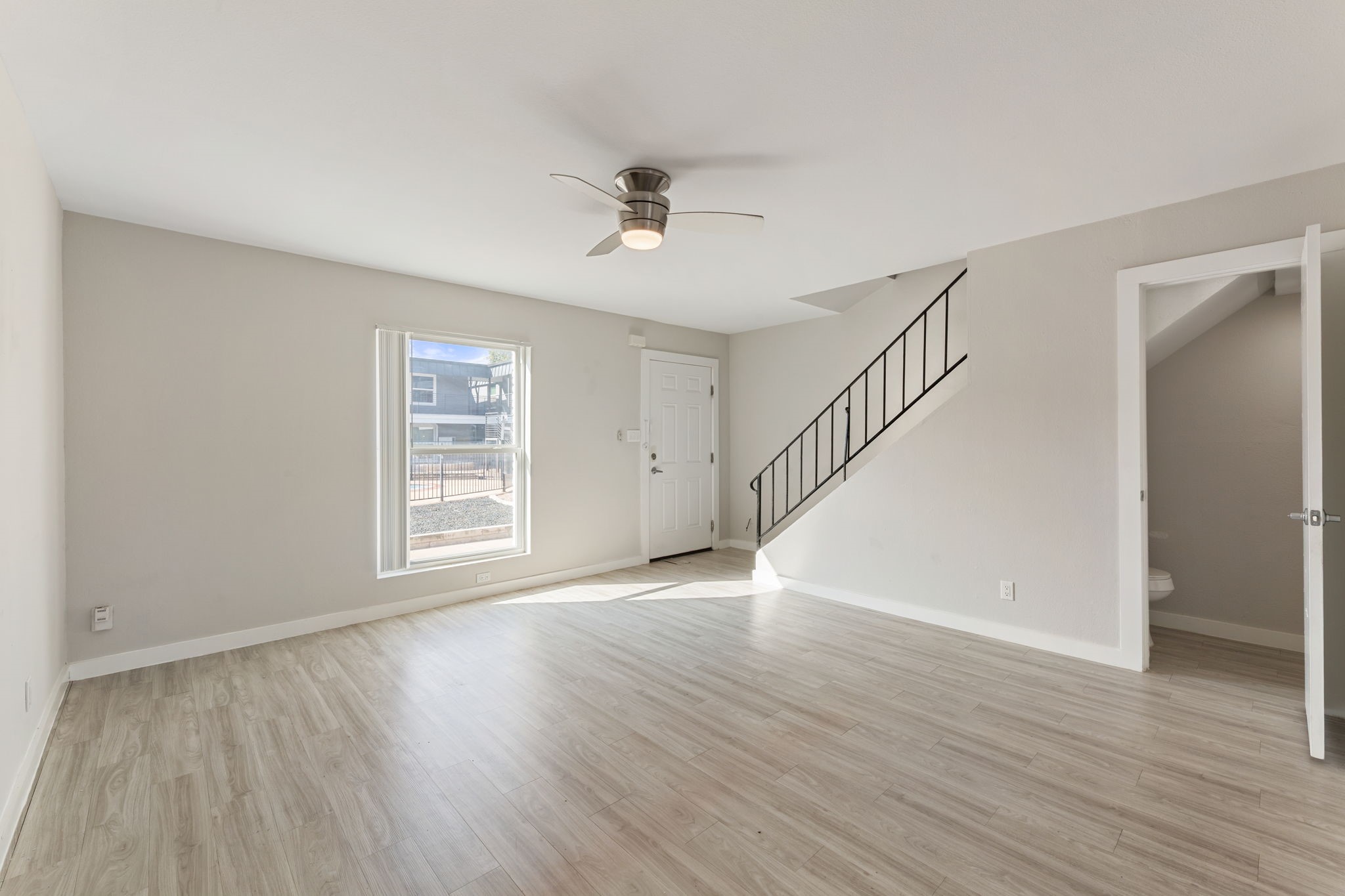 5005 Manor Road, Unit 122 Austin, TX 78723 - Photo 15 of 35 a view of an empty room with wooden floor and a window
