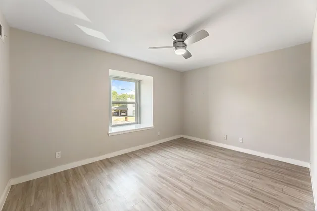 a bedroom with bed and a potted plant