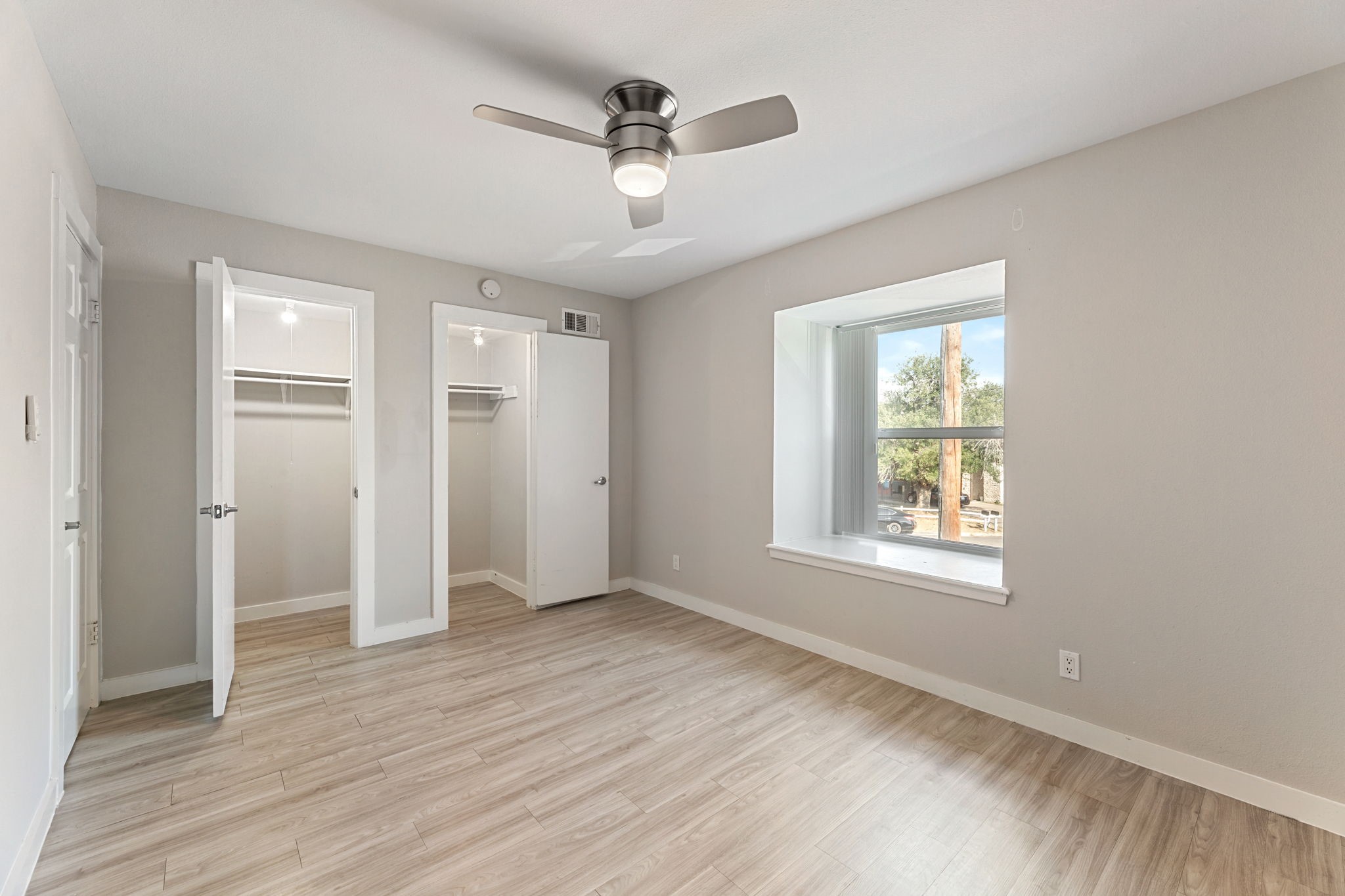 5005 Manor Road, Unit 122 Austin, TX 78723 - Photo 18 of 35 a view of an empty room with a window and wooden floor