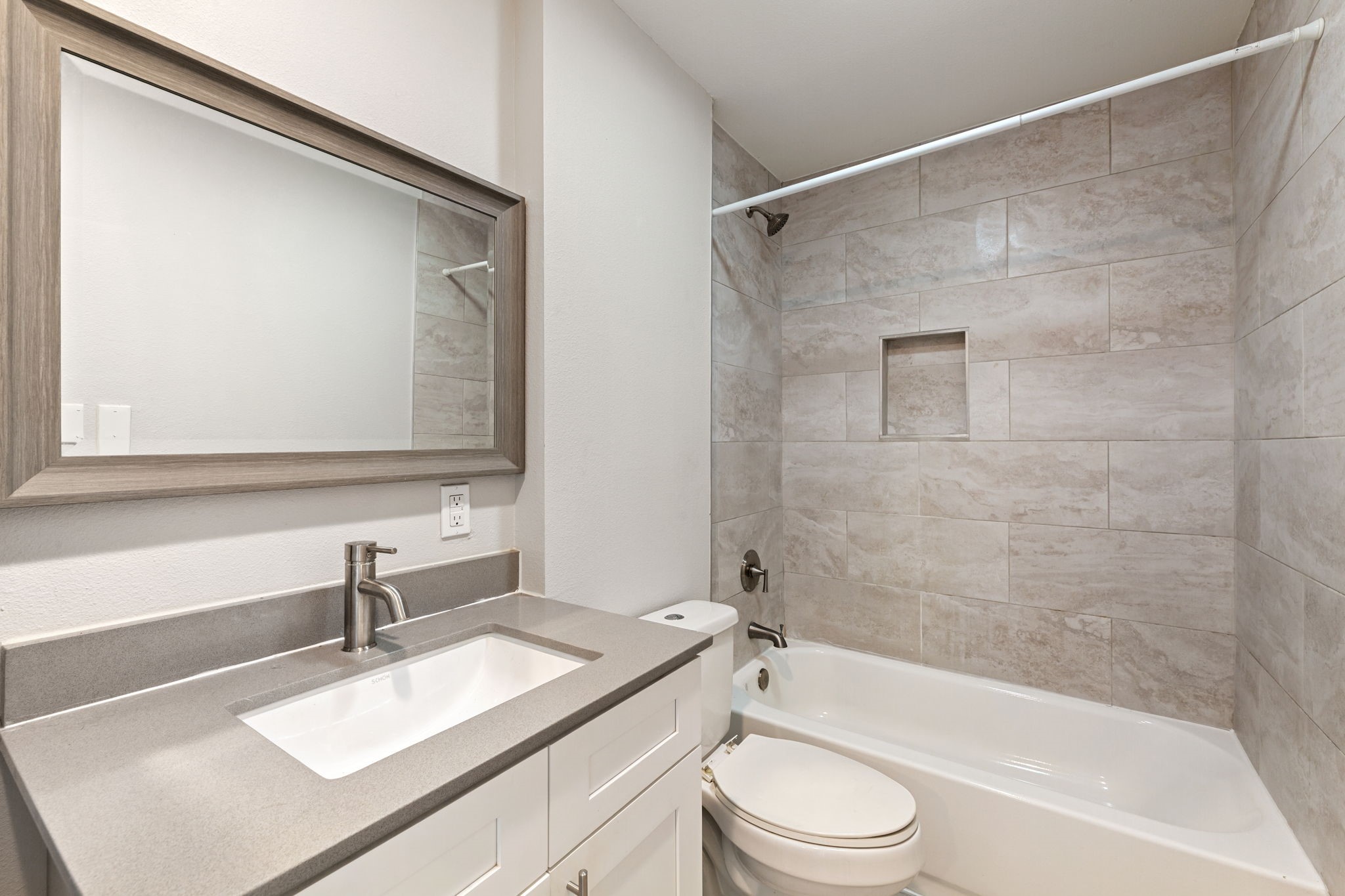5005 Manor Road, Unit 122 Austin, TX 78723 - Photo 20 of 35 a bathroom with a granite countertop sink mirror toilet and bathtub