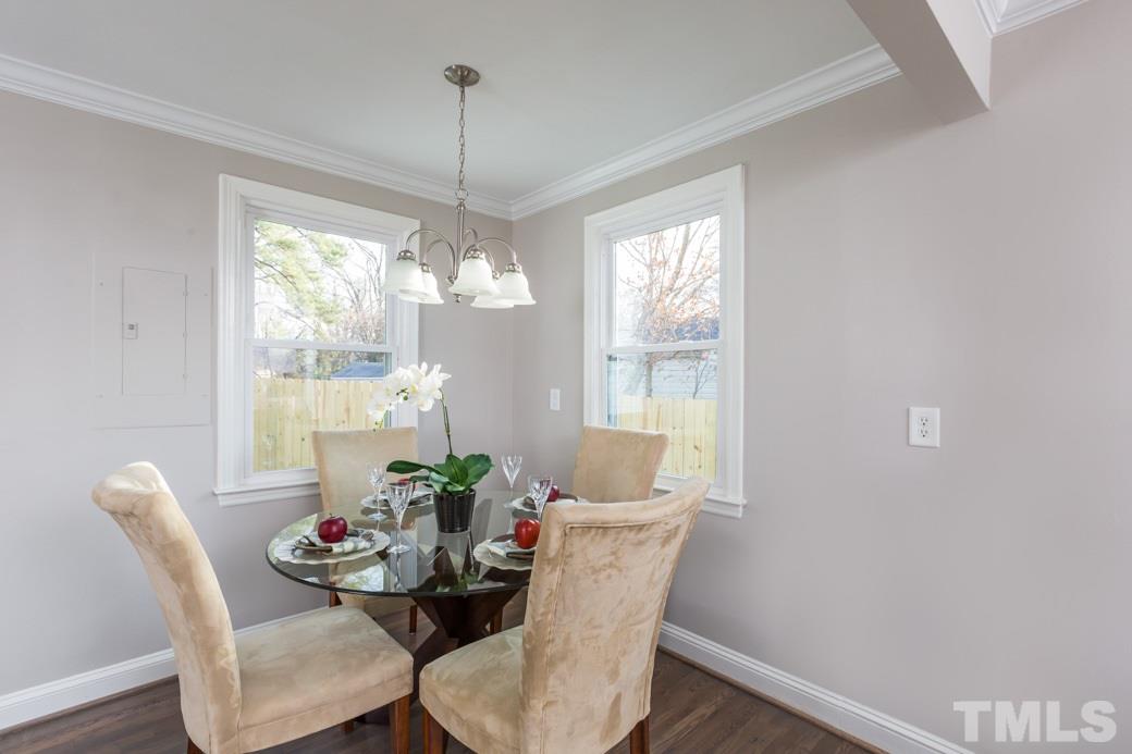 820 Colleton Road Raleigh, NC 27610 - Photo 15 of 25 a dining room with furniture a chandelier and wooden floor