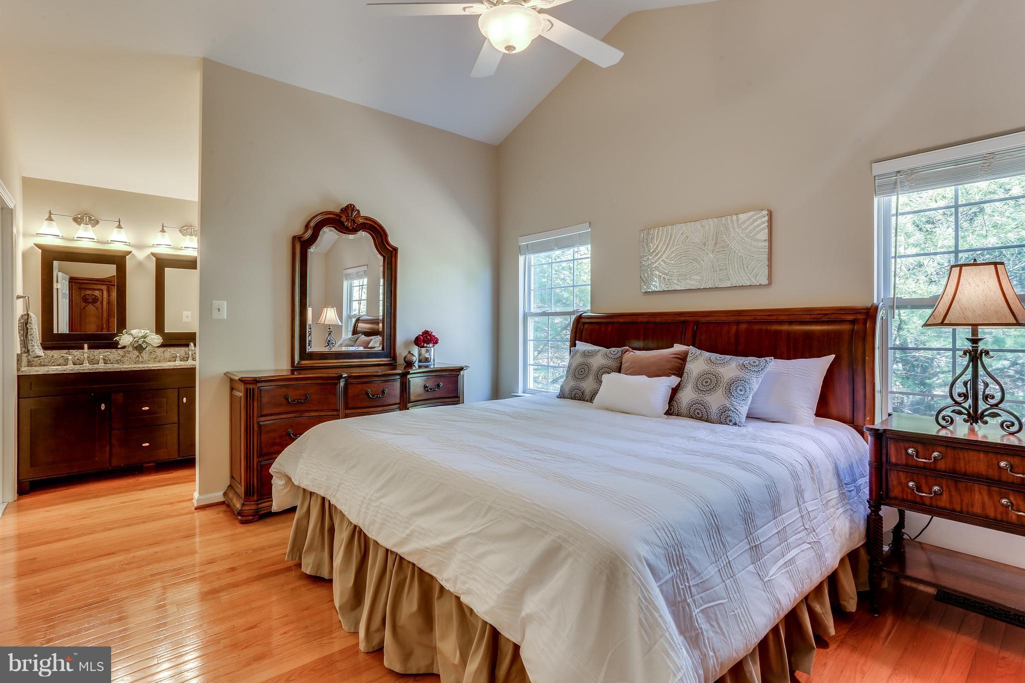 6141 Good Hunters Ride Columbia, MD 21045 - Photo 14 of 28 a spacious bedroom with a bed and a chandelier