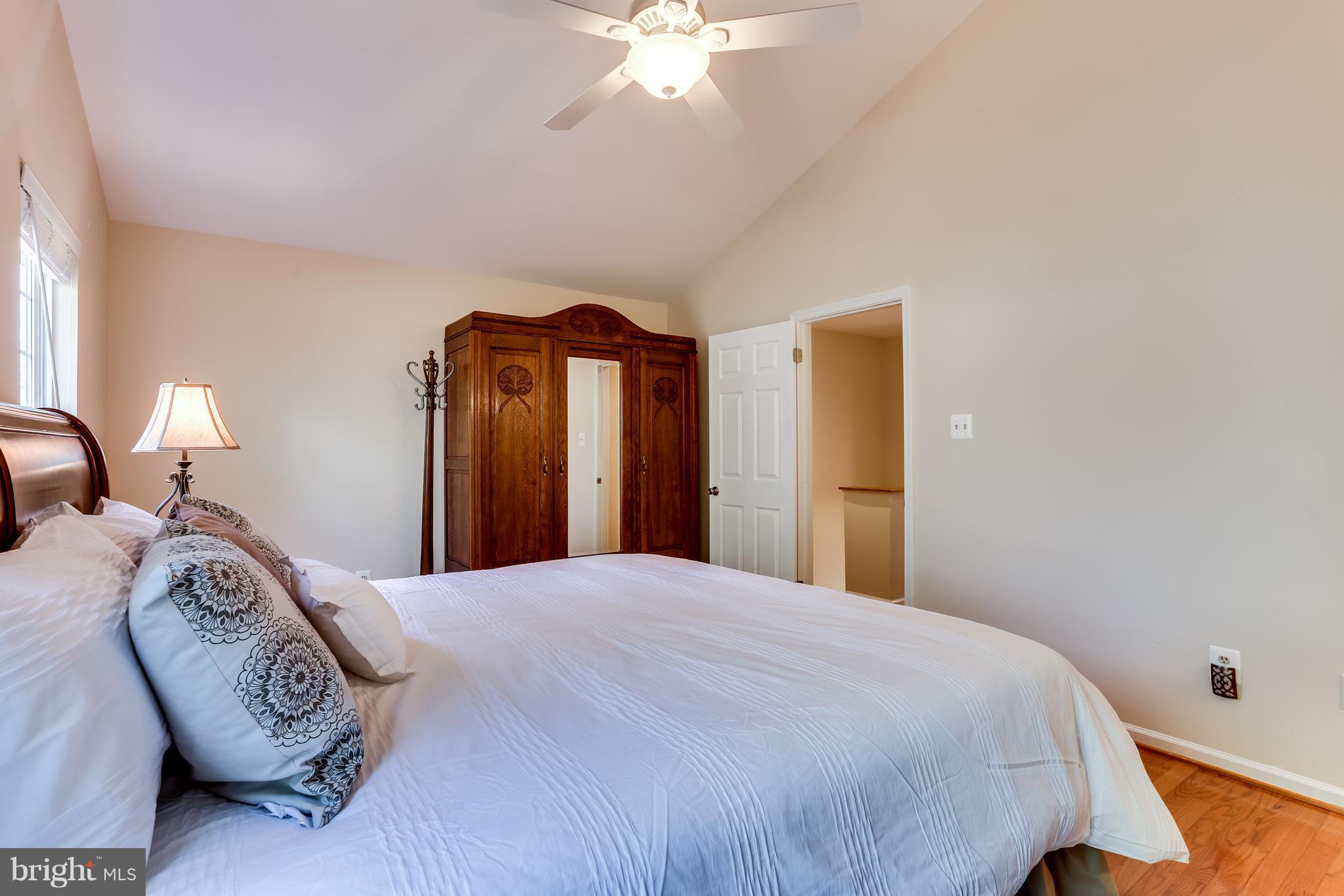 6141 Good Hunters Ride Columbia, MD 21045 - Photo 15 of 28 a bedroom with a bed and a chandelier