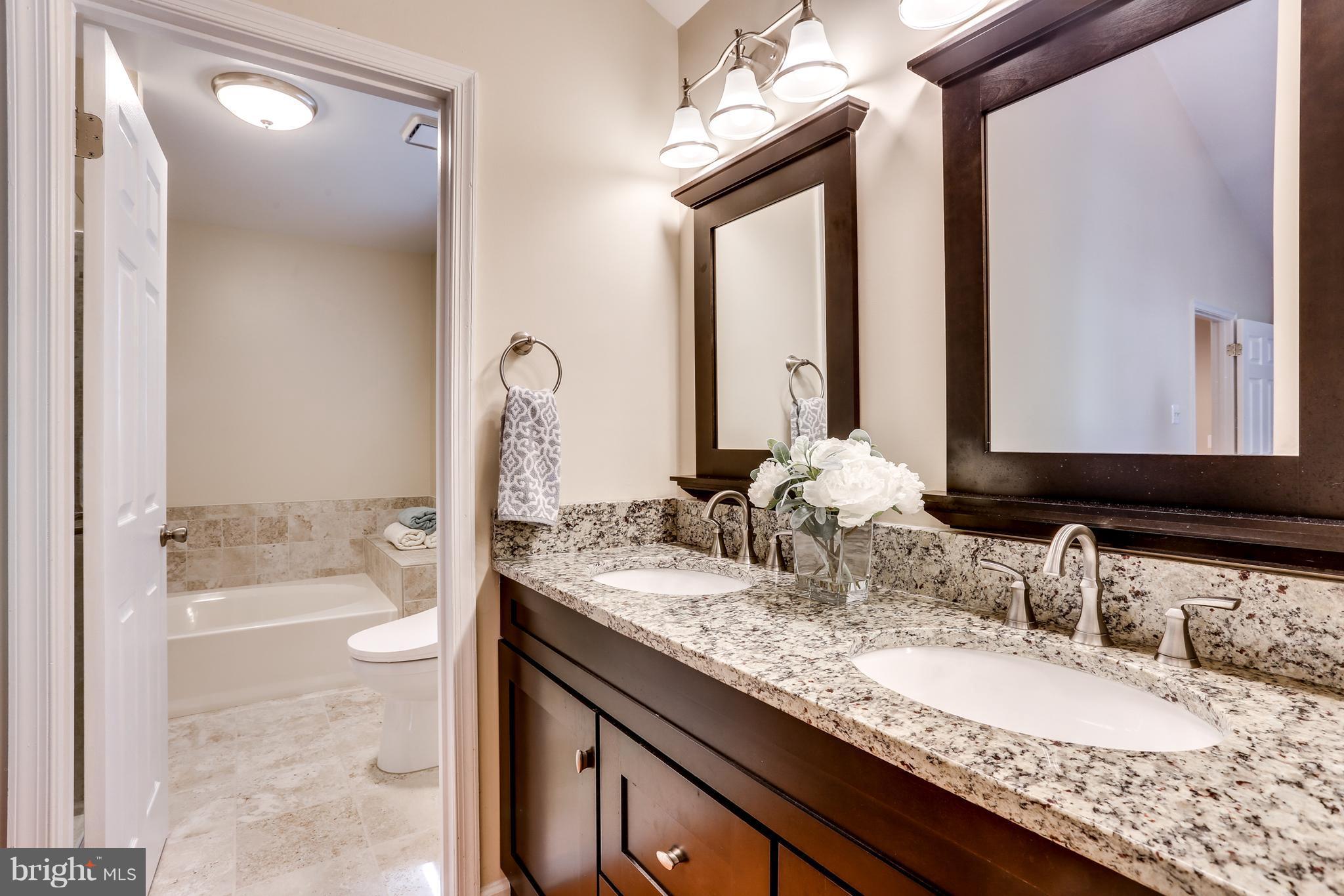 6141 Good Hunters Ride Columbia, MD 21045 - Photo 16 of 28 a bathroom with a granite countertop sink and a mirror