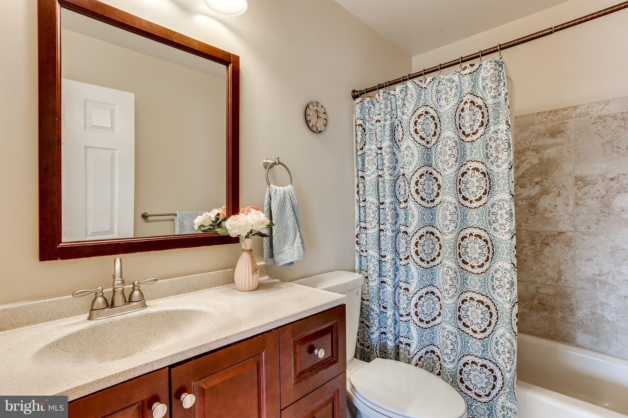 6141 Good Hunters Ride Columbia, MD 21045 - Photo 21 of 28 a bathroom with a granite countertop toilet sink and mirror