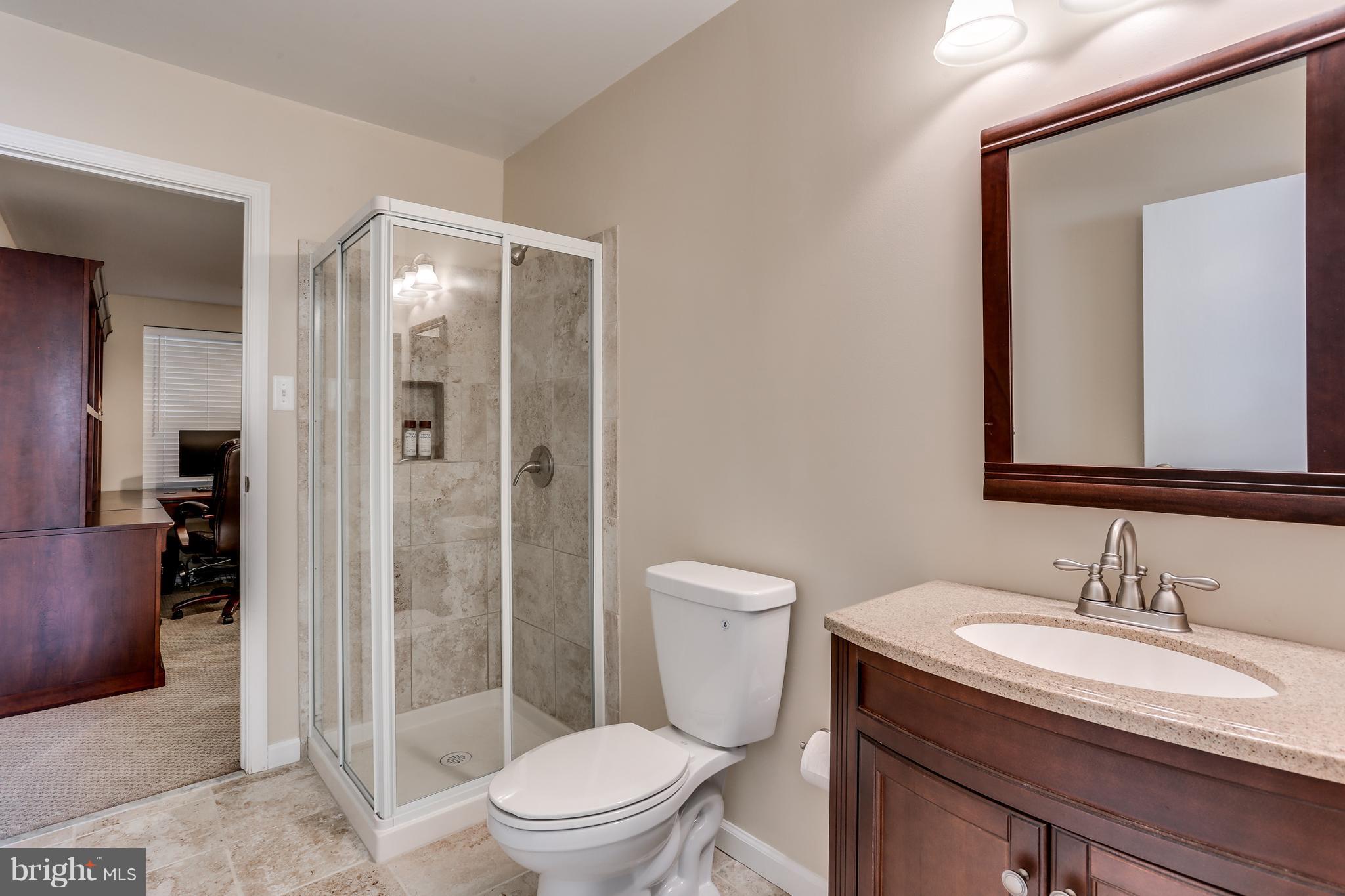 6141 Good Hunters Ride Columbia, MD 21045 - Photo 26 of 28 a bathroom with a granite countertop sink a toilet and shower
