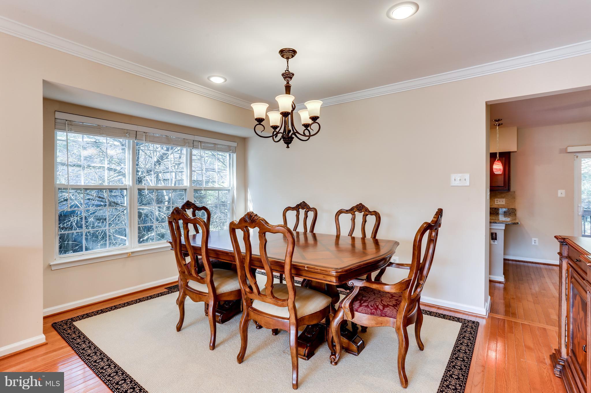 6141 Good Hunters Ride Columbia, MD 21045 - Photo 5 of 28 a dining room with furniture a chandelier and wooden floor