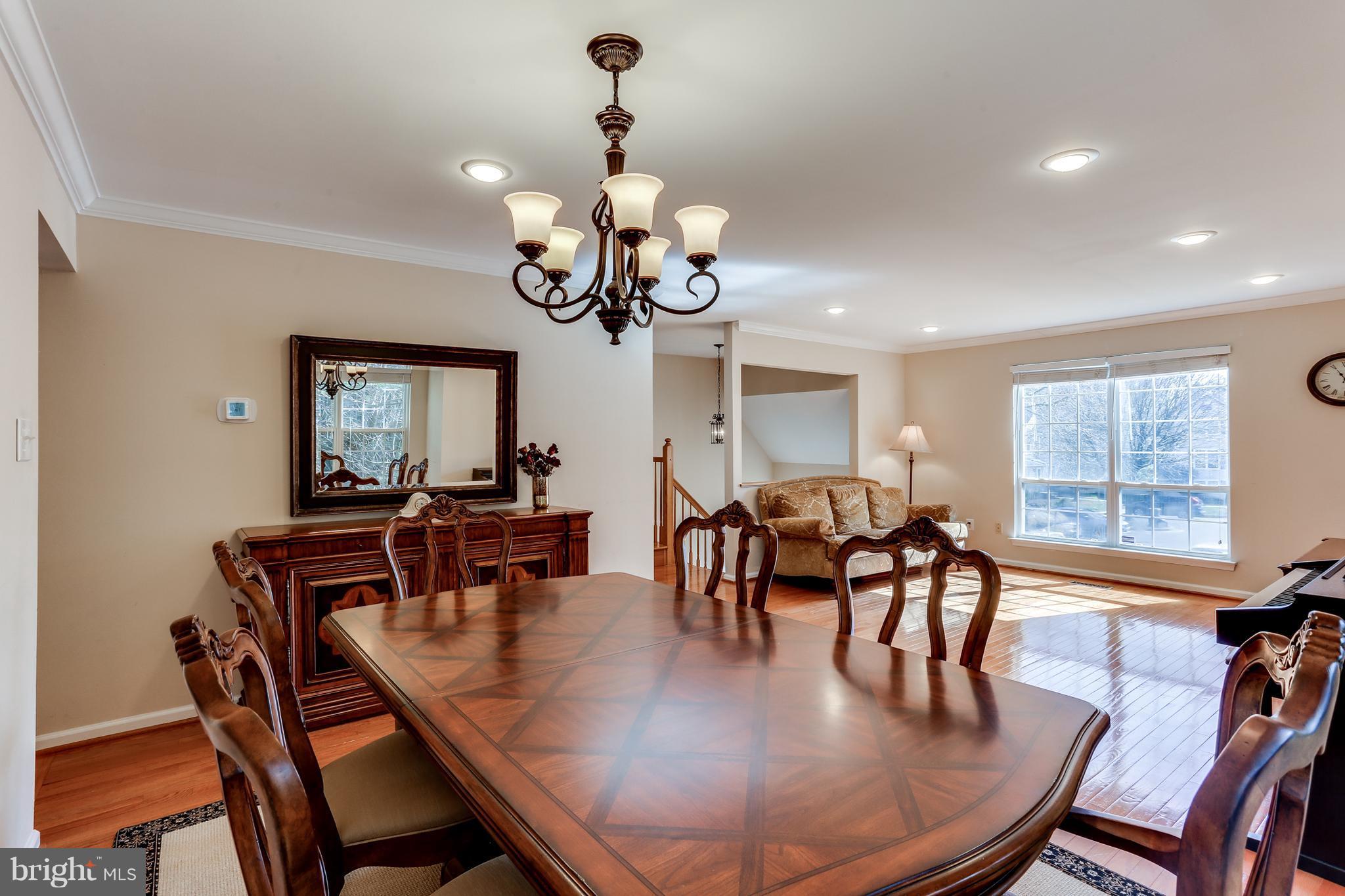 6141 Good Hunters Ride Columbia, MD 21045 - Photo 6 of 28 a view of a dining room with furniture a chandelier and wooden floor