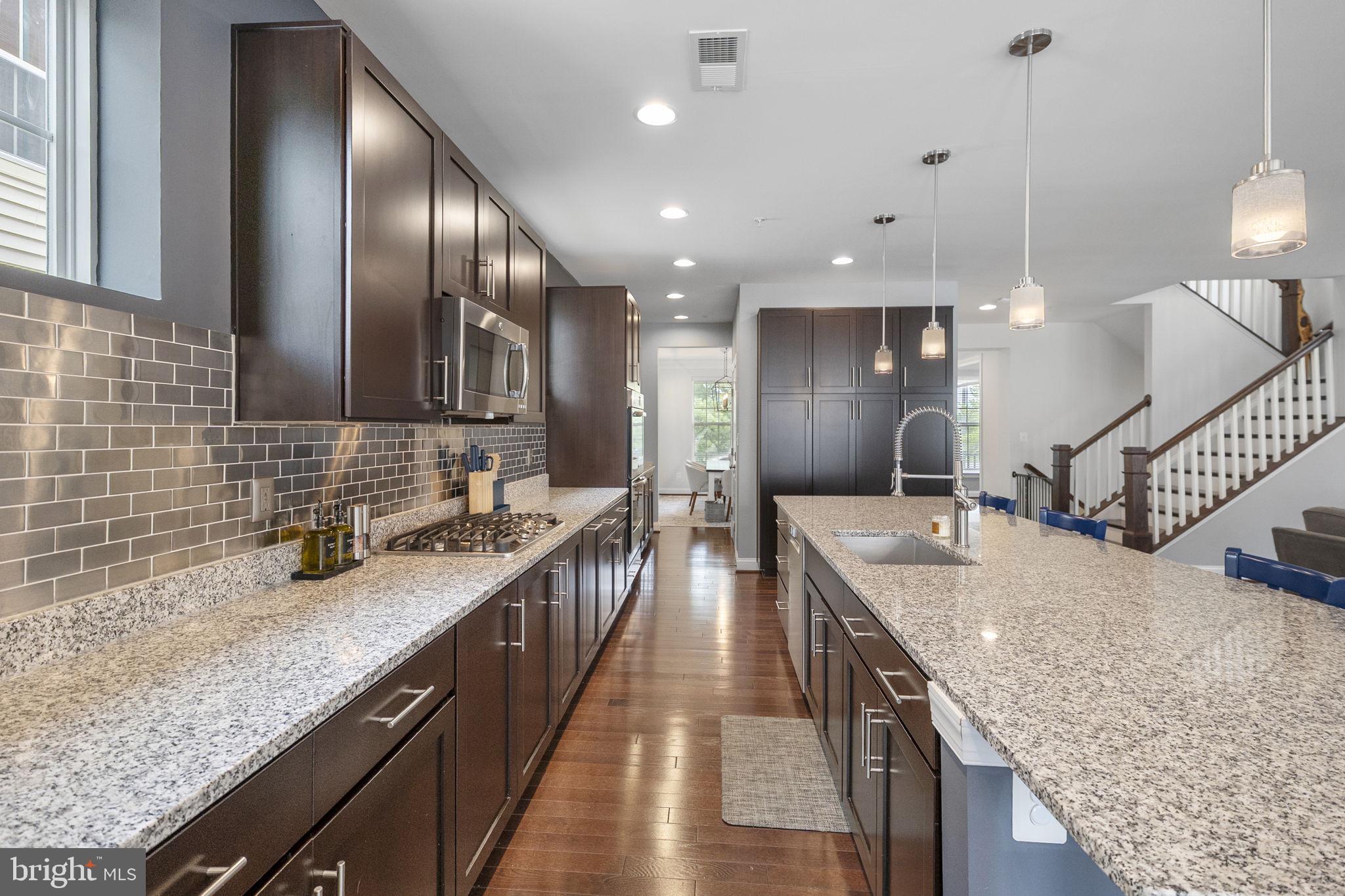 23902 Grapevine Ridge Terrace Clarksburg, MD 20871 - Photo 10 of 44 a kitchen with stainless steel appliances granite countertop plenty wooden cabinets