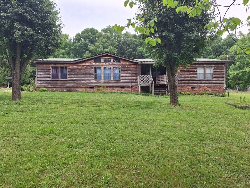 44 Price Jenkins Road Leoma, TN 38468 - Photo 1 of 1 a wooden house with a yard