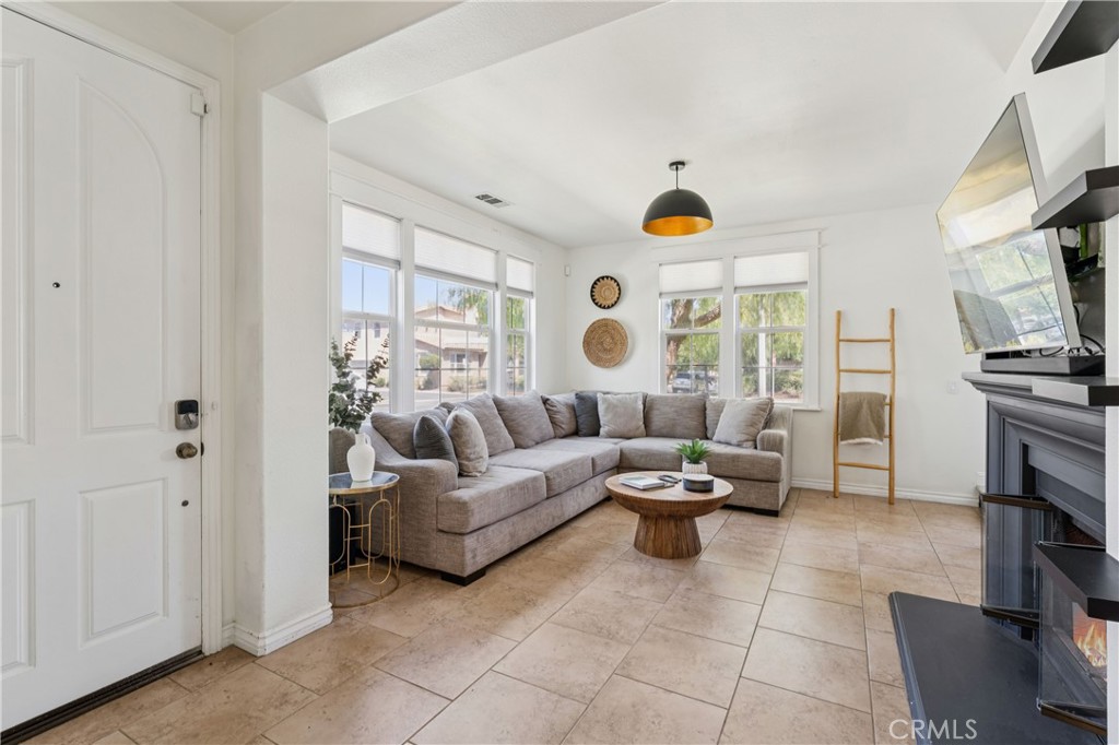 4155 Windspring Street Corona, CA 92883 - Photo 16 of 38 a living room with fireplace furniture and a large window