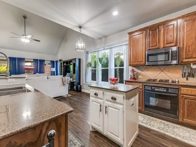 a kitchen with a stove a sink and a microwave
