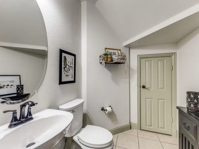 a bathroom with a toilet a sink and mirror