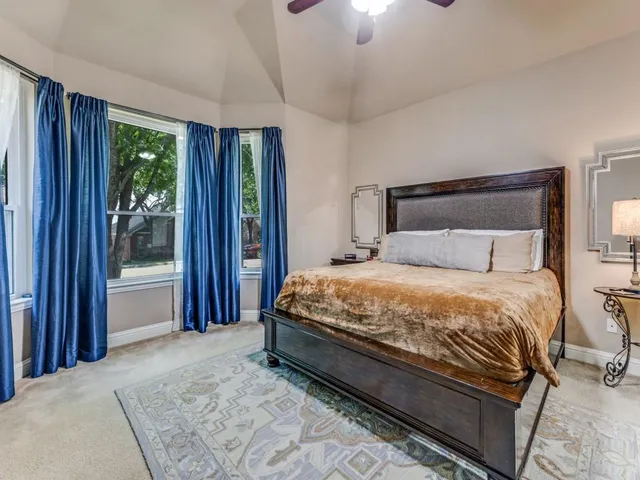 a bedroom with a large bed and a window