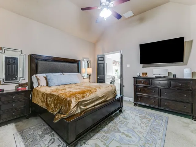 a bed room with a bed and a television