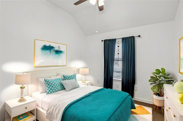 a bedroom with a bed and a potted plant