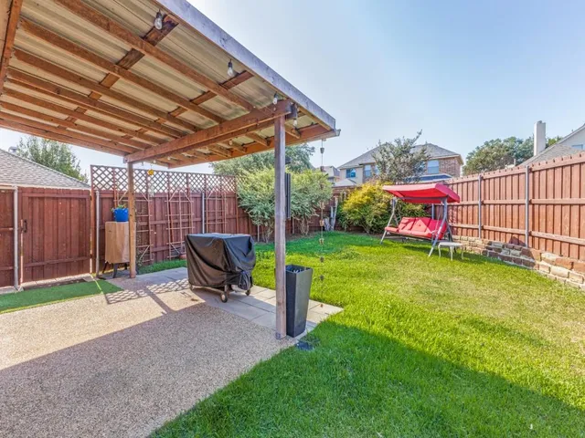 a view of a backyard with a small cabin and sitting area