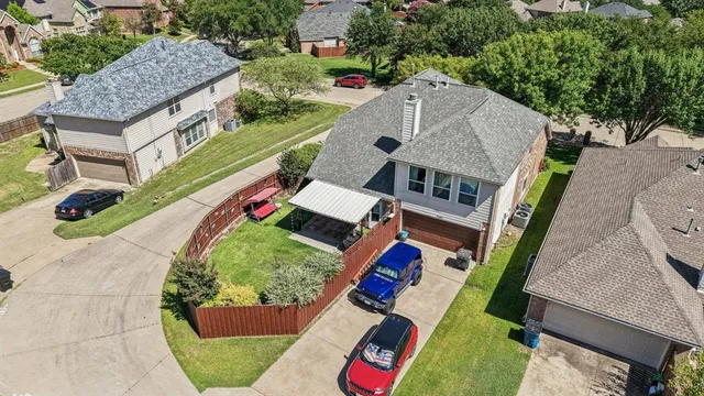 an aerial view of a house with a yard and potted plants
