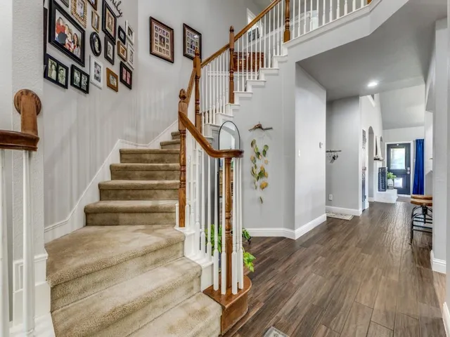 a view of entryway and hall with wooden floor