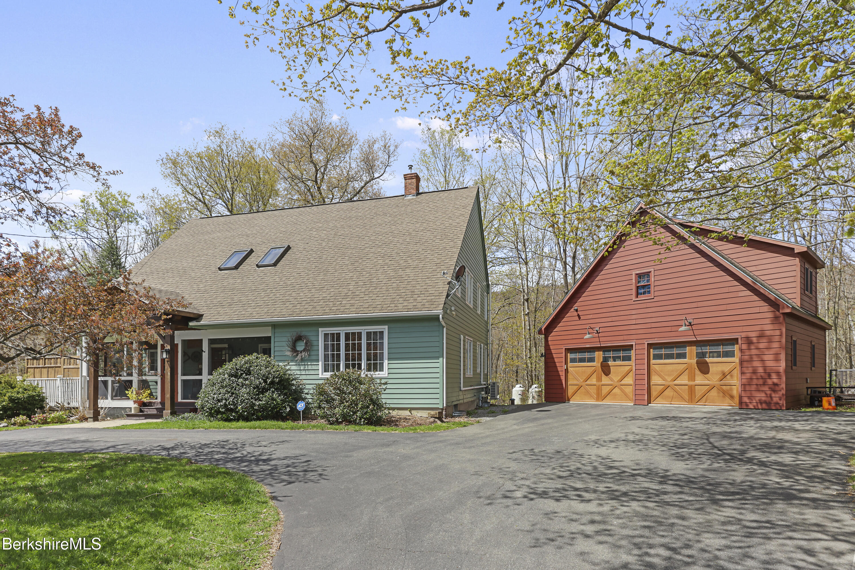 167 Bailey Road Lanesborough, MA 01237 - Photo 2 of 71 a front view of a house with a garden and trees
