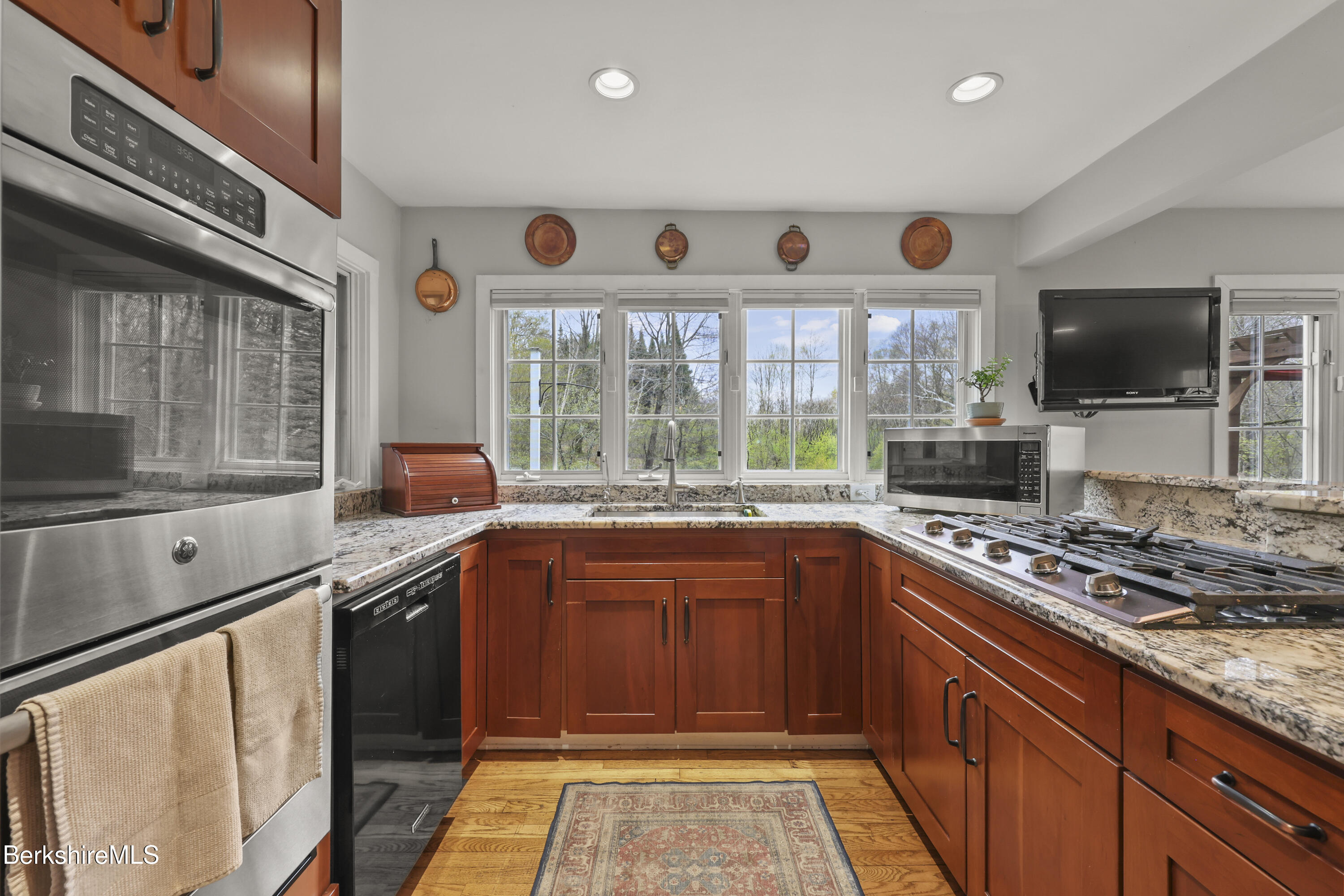 167 Bailey Road Lanesborough, MA 01237 - Photo 10 of 71 a kitchen with stainless steel appliances granite countertop a stove and a sink