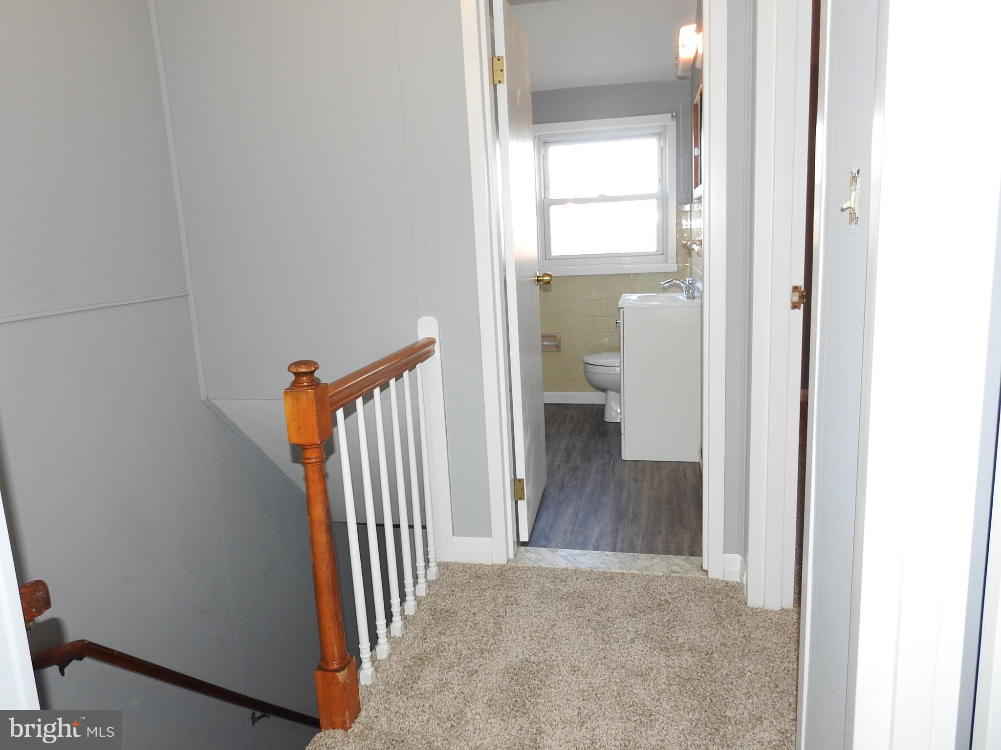 7828 Charlesmont Road Baltimore, MD 21222 - Photo 13 of 22 a view of a hallway with a room and a room