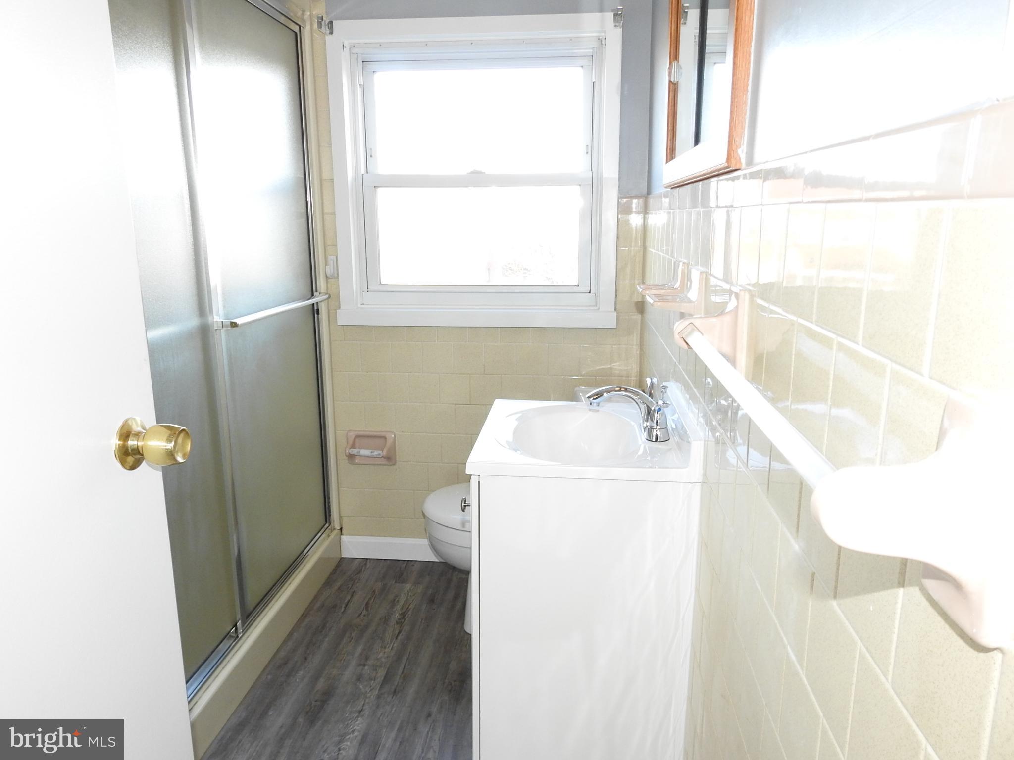 7828 Charlesmont Road Baltimore, MD 21222 - Photo 14 of 22 a bathroom with a sink and a vanity