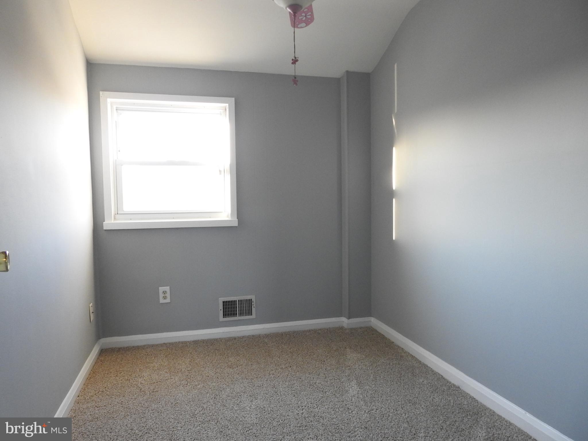 7828 Charlesmont Road Baltimore, MD 21222 - Photo 18 of 22 an empty room with a window