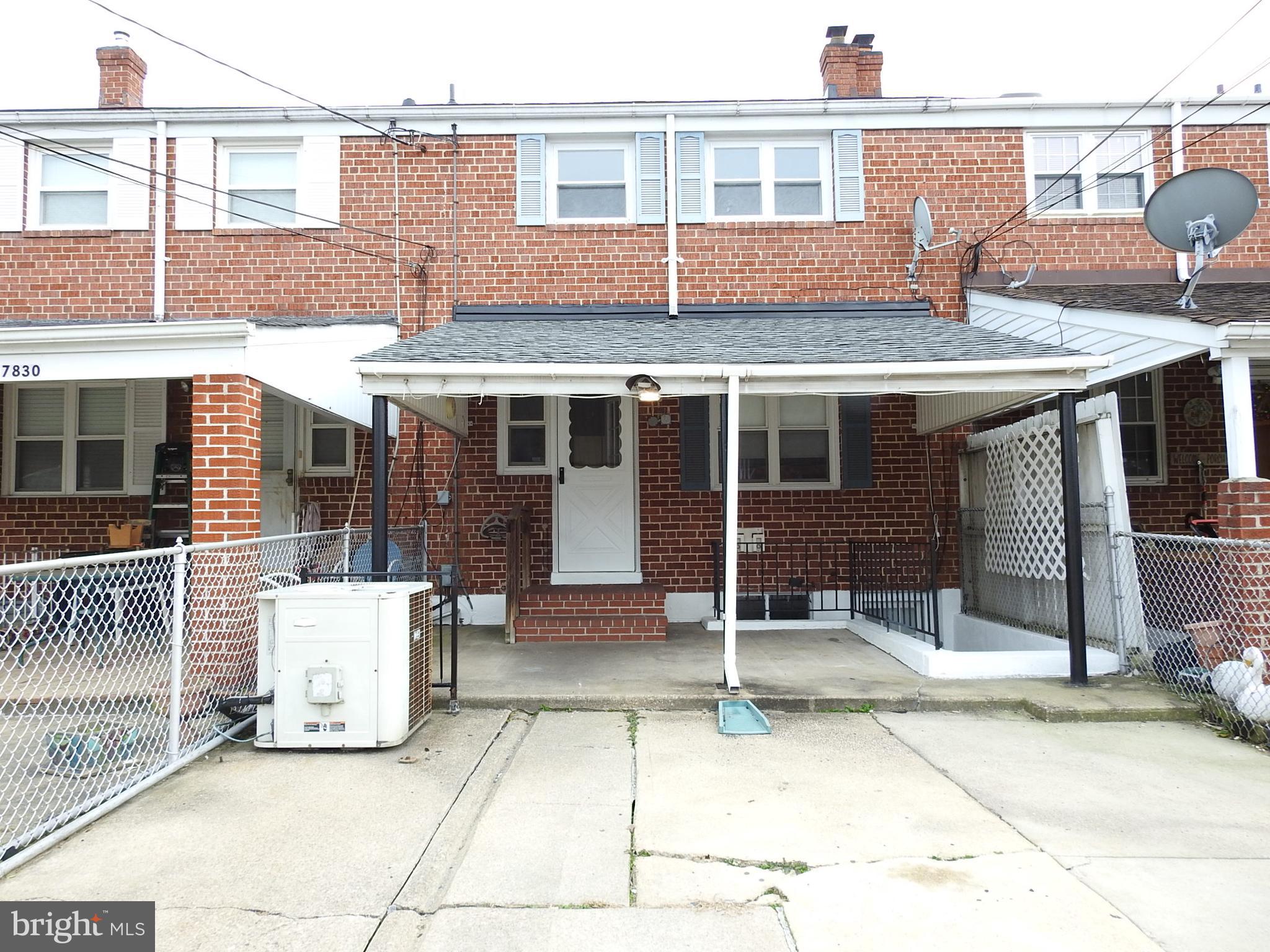 7828 Charlesmont Road Baltimore, MD 21222 - Photo 20 of 22 a front view of a house with a garage