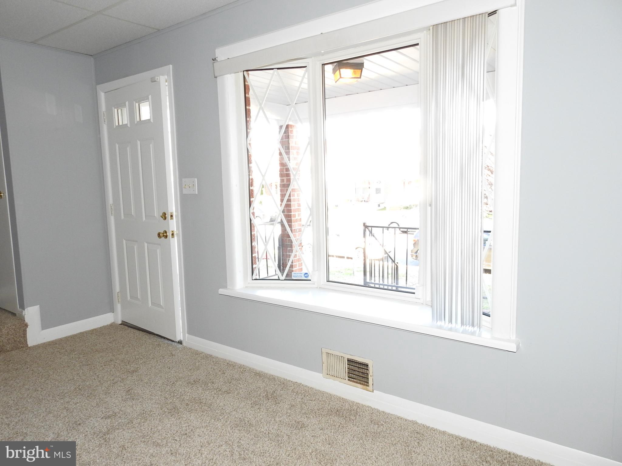 7828 Charlesmont Road Baltimore, MD 21222 - Photo 3 of 22 a view of an empty room with a window