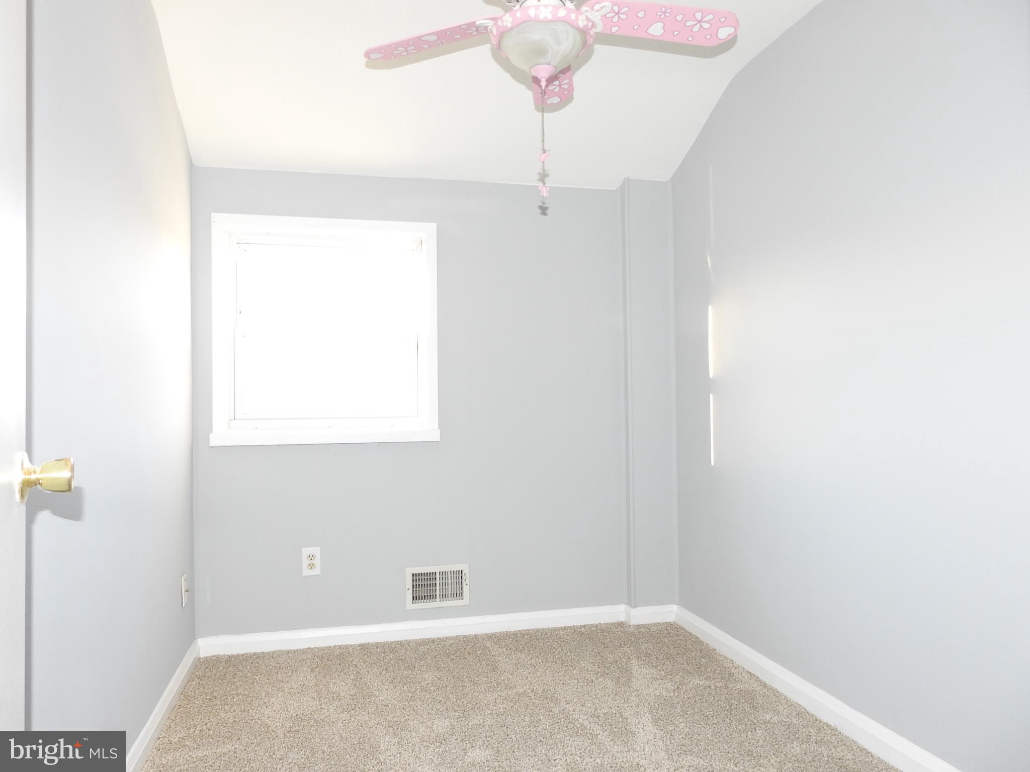7828 Charlesmont Road Baltimore, MD 21222 - Photo 10 of 22 a view of an empty room with a window