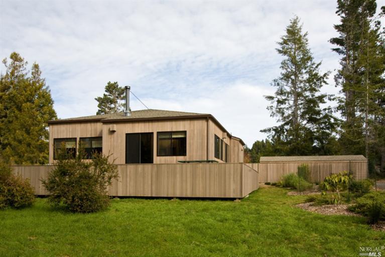 35901 Sea Ridge Road The Sea Ranch, CA 95497 - Photo 1 of 1 a backyard of a house with table and chairs
