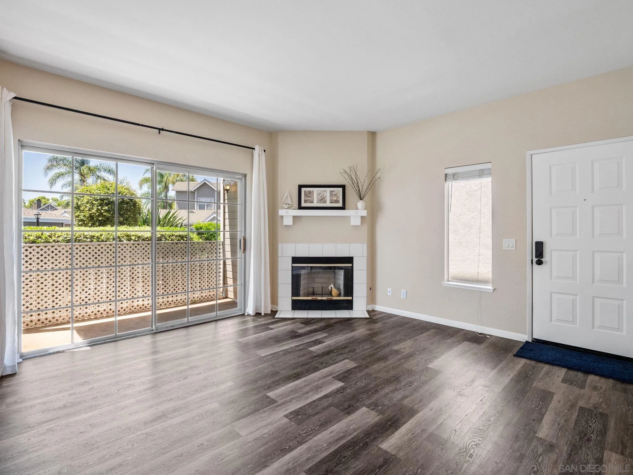 13808 Midland Road Poway, CA 92064 - Photo 4 of 19 a view of an empty room with wooden floor and a window