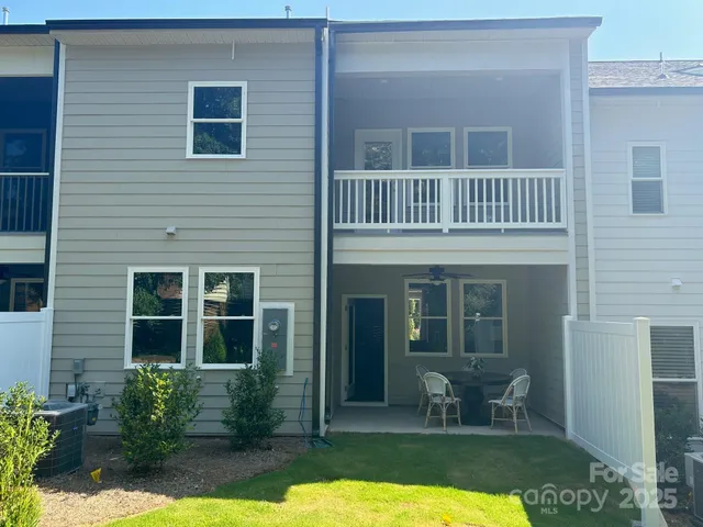 a view of a house with backyard porch and sitting area