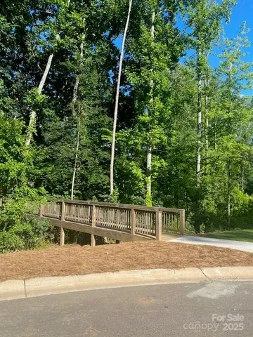 a view of a fence and trees