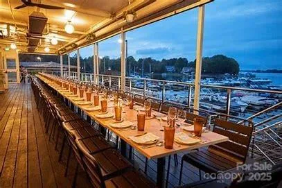 a view of a balcony with chairs and wooden floor