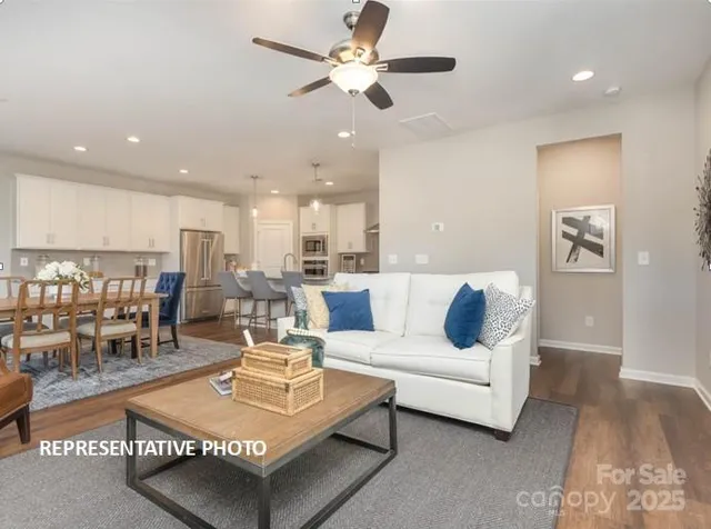 a living room with furniture and kitchen view