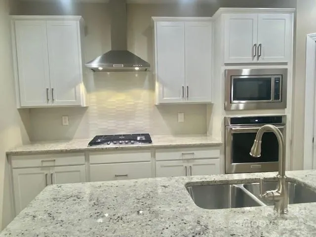 a kitchen with a sink stove and cabinets