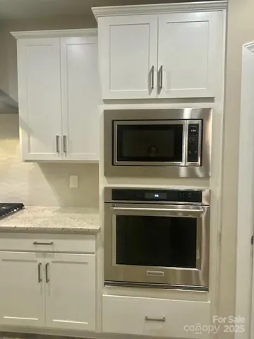 a stove top oven sitting inside of a kitchen
