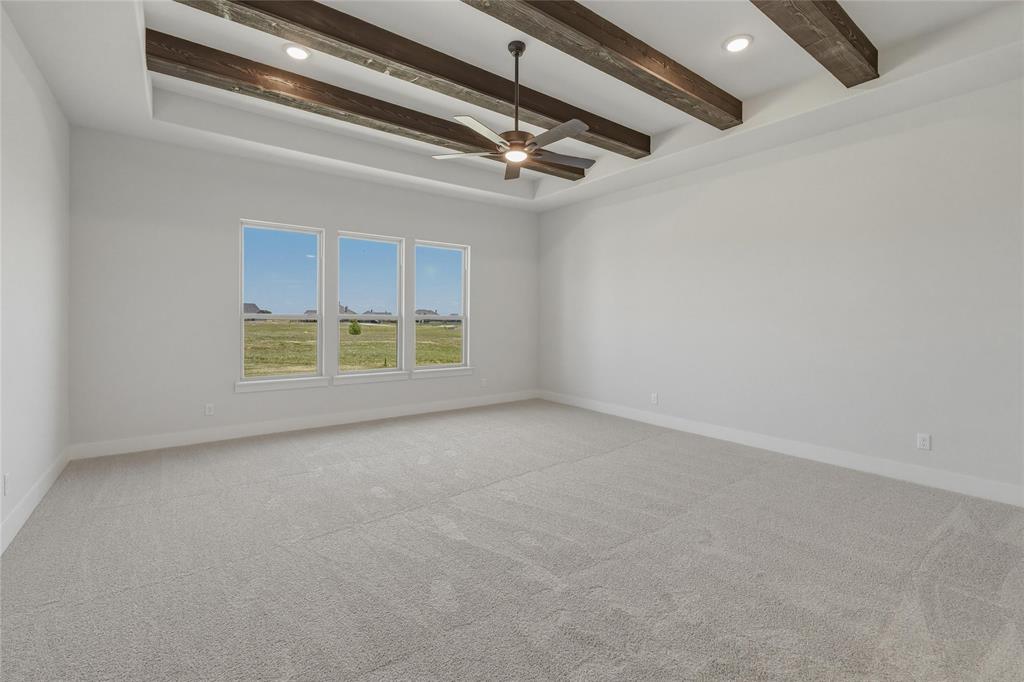 2305 Gypsum Street Krum, TX 76249 - Photo 14 of 26 Spacious room featuring a tray ceiling with exposed wood beams and recessed lighting