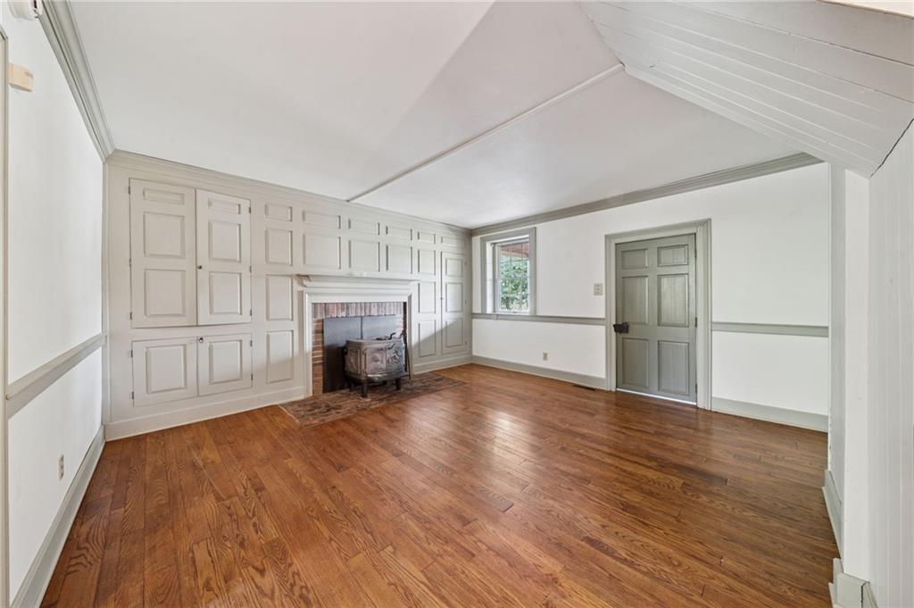 284 Eaton Run Road Jefferson, PA 15344 - Photo 13 of 41 wooden floor fireplace and windows in an empty room