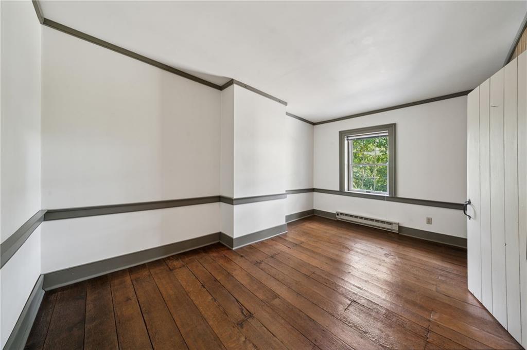 284 Eaton Run Road Jefferson, PA 15344 - Photo 20 of 41 a view of an empty room with wooden floor and a window