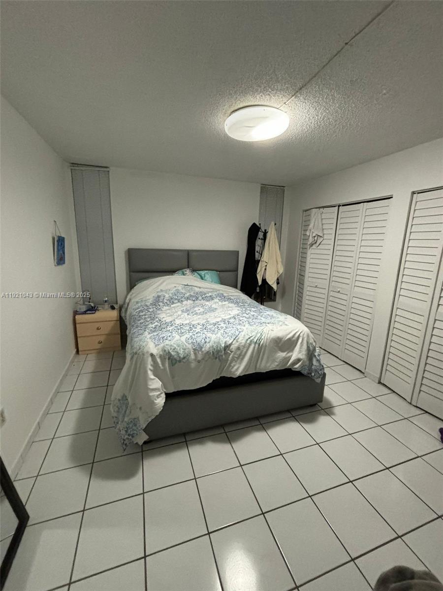 9431 Southwest 4th Street, Unit 201 Miami, FL 33174 - Photo 2 of 6 a bedroom with a bed and a shower