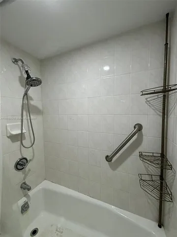 a bathroom with a shower and a bath tub
