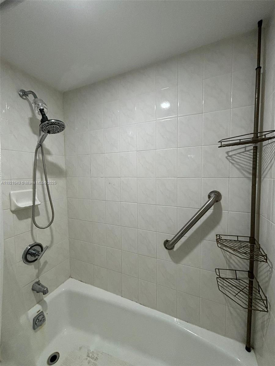 9431 Southwest 4th Street, Unit 201 Miami, FL 33174 - Photo 3 of 6 a bathroom with a shower and a bath tub