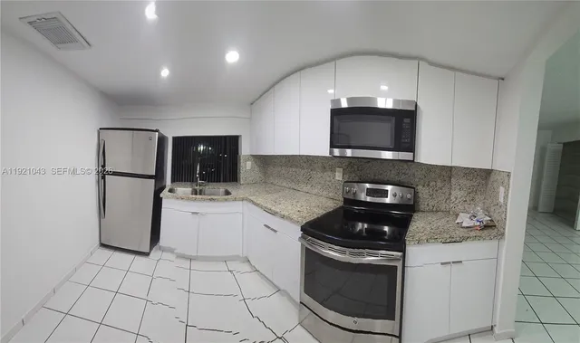 a kitchen with a sink a stove and refrigerator