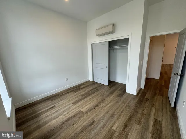a view of a room with wooden floor and staircase